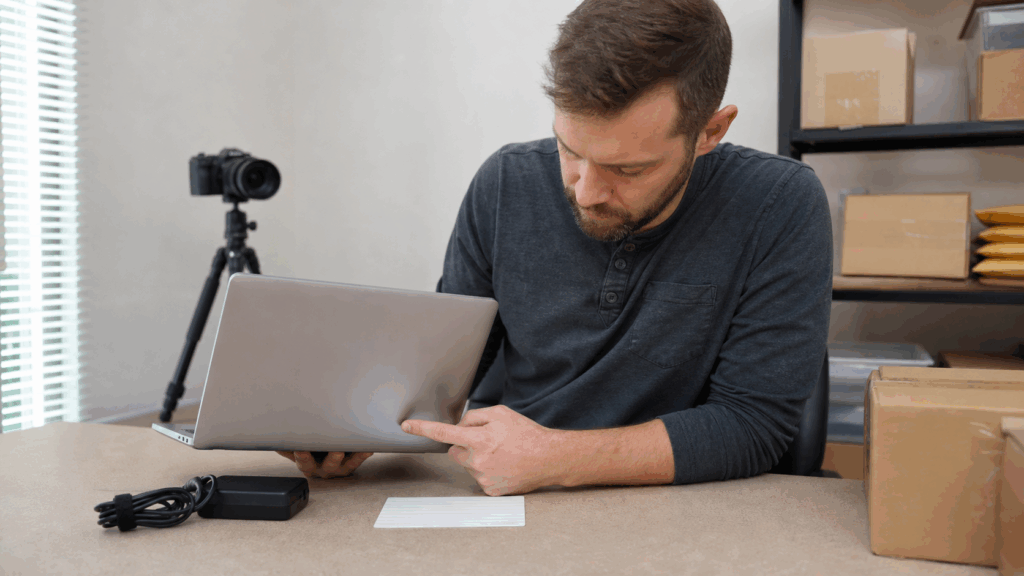 Seller inspecting the ports of a used laptop before writing an eBay listing description